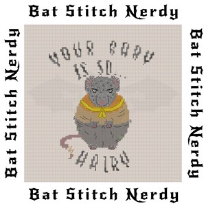 May include: Cross-stitch pattern featuring a gray rat with a yellow hooded cloak. The rat is sitting with its paws crossed and has a grumpy expression. The text above the rat reads "Your body is so hairy".