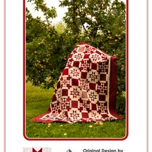 May include: A red and white quilt with a star pattern. The quilt is folded and displayed in a garden setting. The quilt is available in lap, double, and queen sizes. The text "COLOUR MY QUILT" is at the top of the image. The text "Original Design by Carla Alexiuk | 2021" is at the bottom of the image. The text "Lap 60" x 78", Double 78" x 96", Queen 96" x 96" is also at the bottom of the image.