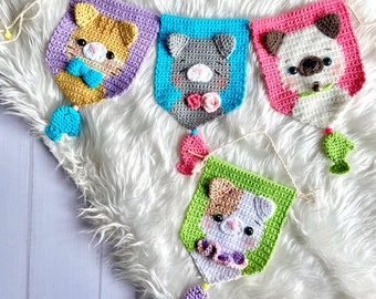 May include: A colorful crocheted banner with four animal faces. Each face is a different color and has a fish hanging from the bottom. The animals are a cat, a dog, a cat, and a dog.
