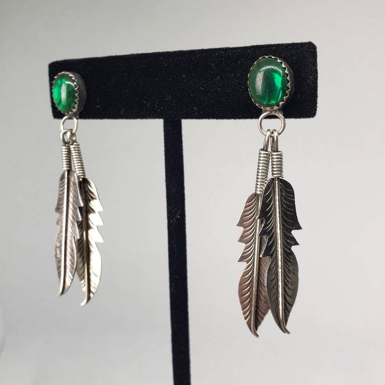 Silver Dangling Feather Earrings with Green Stones