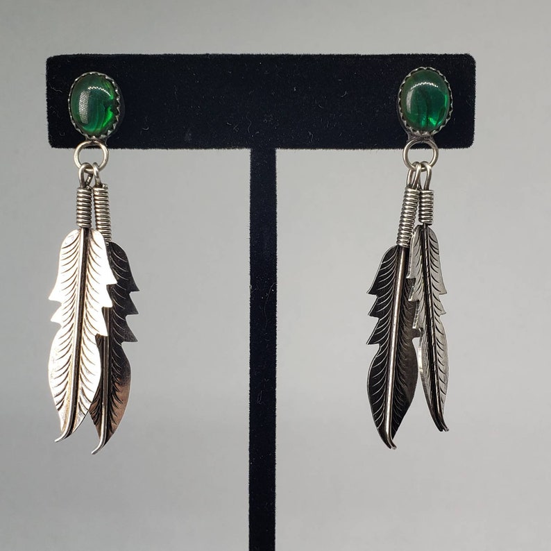 Silver Dangling Feather Earrings with Green Stones