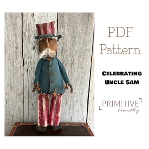 May include: A PDF pattern for a handmade doll, "Celebrating Uncle Sam", a patriotic figure with a red, white, and blue hat, blue jacket, and red and white striped pants. The pattern is by Primitive Timothy.