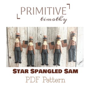 May include: Five handmade Uncle Sam dolls with white beards, striped shirts, and star-spangled pants hang on a string with miniature American flags. The text "STAR SPANGLED SAM PDF Pattern" is below.