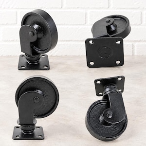 May include: A set of four black metal swivel castors, each featuring a circular wheel attached to a square mounting plate with four pre-drilled holes. These industrial-style castors are designed for mobility and include a central pivot mechanism.