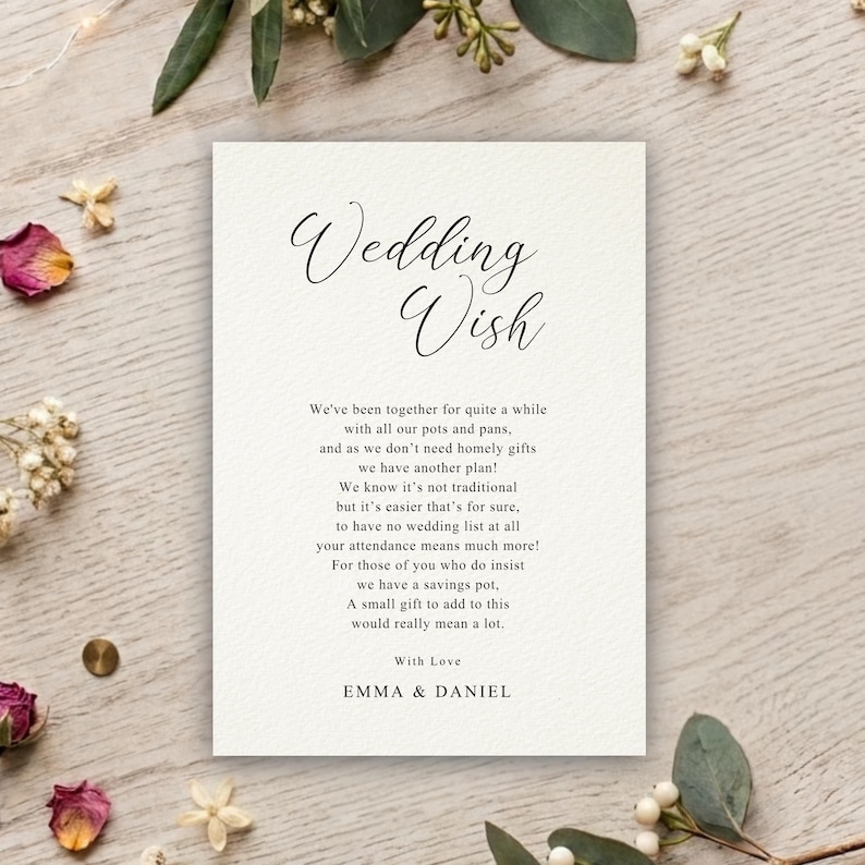 May include: A rectangular white wedding wish card with black text featuring the title Wedding Wish, a poem about a savings pot, and the names Emma & Daniel at the bottom. The card has a textured paper finish and is printed in a serif font.