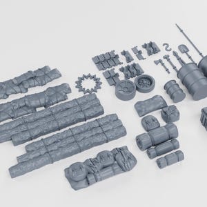 May include: A selection of grey miniature terrain pieces, including logs, barrels, and tools. The set is designed for tabletop gaming or model building, with a post-apocalyptic or survival theme.
