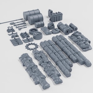 May include: A collection of grey miniature objects, including barrels, tools, wheels, and wrapped bundles. The items appear to be model-making supplies or components for a larger project. The items are arranged on a white surface.