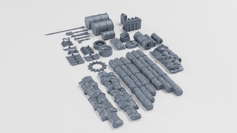 May include: A collection of grey miniature objects, including barrels, tools, wheels, and wrapped bundles. The items appear to be model-making supplies or components for a larger project. The items are arranged on a white surface.