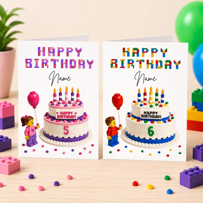 May include: Two birthday cards with Lego-themed designs. Each card features a cake with candles, a Lego figure holding a balloon, and the words "Happy Birthday" in colourful block letters. One card shows the number 5, the other shows the number 6.