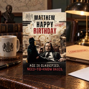 May include: A rectangular greeting card featuring a vintage, spy-themed design with the text MATTHEW HAPPY BIRTHDAY and CLASSIFIED in red. The image shows a person in a suit with a foot in a holey sock raised, with the text AGE IS CLASSIFIED. NEED-TO-KNOW BASIS.