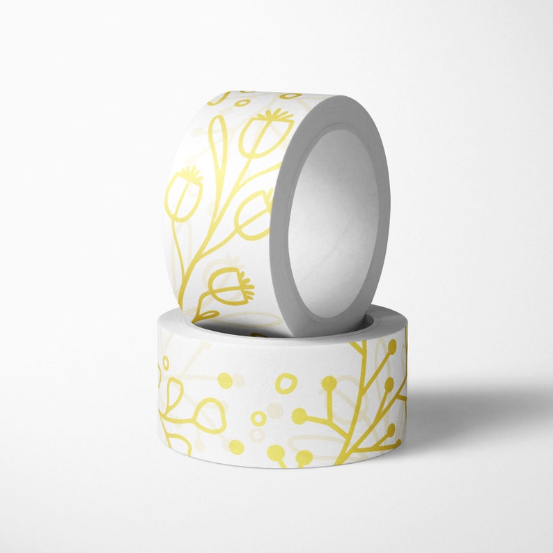 May include: Two rolls of white washi tape with a gold floral pattern. The tape is decorated with a simple, hand-drawn floral design.