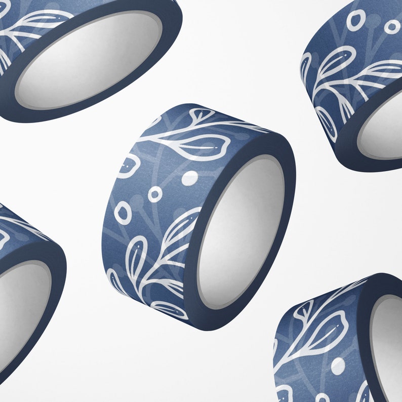 May include: Four rolls of blue washi tape with a white floral pattern. The tape is rolled up and the ends are visible.