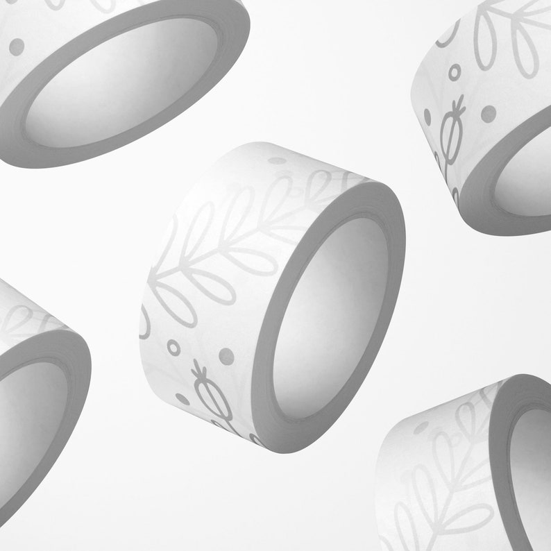 May include: Four rolls of white washi tape with different patterns. The patterns include leaves, dots, and a floral design.
