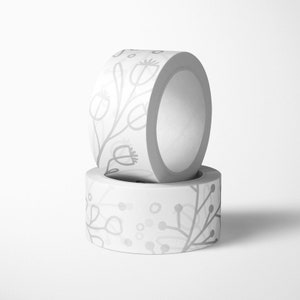May include: Two rolls of white washi tape with a floral pattern. The tape has a gray floral design with small dots.