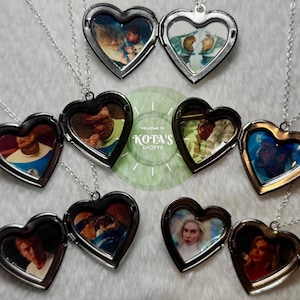 May include: Six silver heart-shaped locket necklaces with different images inside. The lockets are open and show the images inside. The images are of various people and scenes. The lockets are on a white background.