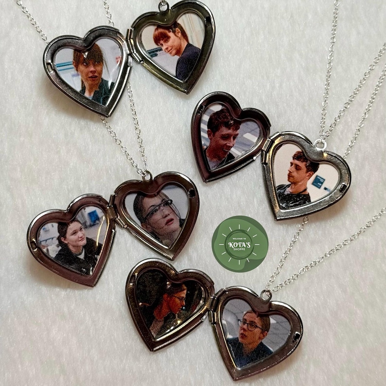 May include: Heart-shaped silver lockets with photos inside, displayed on a white surface. Each locket is open, revealing a different image. The lockets hang from delicate silver chains. The image includes a green and white logo.