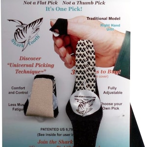 May include: An advertisement for SharkTooth crossover guitar picks. The image shows two picks, one on a finger and another detached. The picks are black with a textured white surface. The text on the advertisement includes "SharkTooth" and "Universal Picking Technique."