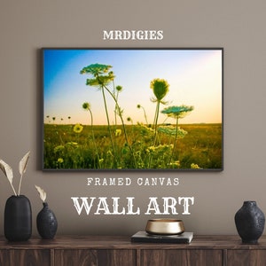 May include: Framed canvas wall art featuring a photograph of a field of wildflowers with a blue sky and clouds in the background. The text "MRDIGIES" is at the top of the image and "FRAMED CANVAS WALL ART" is at the bottom.