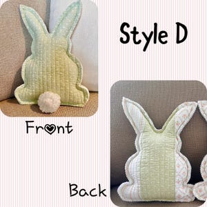 May include: A light green bunny-shaped pillow with a quilted design and a white pom-pom tail. The pillow has a white dotted pattern on the front and a floral pattern on the back. The text "Style D" is visible.