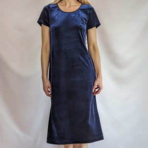 May include: A navy blue velvet midi dress with short sleeves and a round neckline.