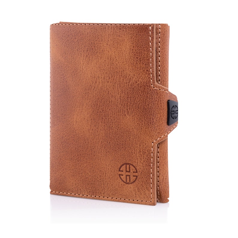 May include: A brown leather wallet with a black logo and a flap closure.