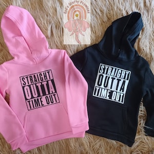 May include: Two hooded sweatshirts, one pink and one black, with the text "STRAIGHT OUTTA TIME OUT" printed on the front.
