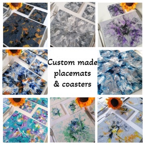May include: A selection of custom-made placemats and coasters with abstract patterns. The placemats and coasters showcase a range of colours, including blue, grey, purple, and yellow. The text "Custom made placemats & coasters" is displayed in the centre.