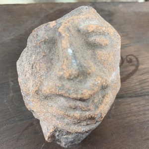 Archaeological find of an ancient stone with a human face
