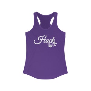 May include: Purple racerback tank top with the text "Huck This" in white cursive lettering with a small berry graphic.