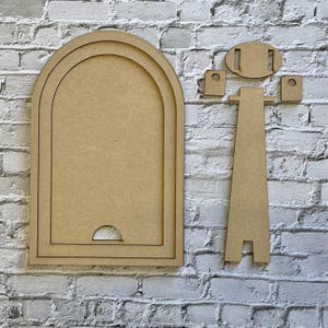 May include: Unfinished wooden arch-shaped frame with a stand and mounting hardware. The frame has a layered design and a cutout at the bottom. The stand is a simple, two-piece design. The pieces are made of light brown wood.