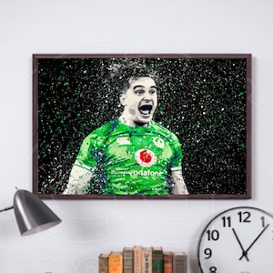 May include: A black and white digital art print of a rugby player wearing a green jersey with a red circle logo and the word "Vodafone" on it. The player is shouting with his mouth open and has a determined expression on his face. The background is a black and white splatter pattern.
