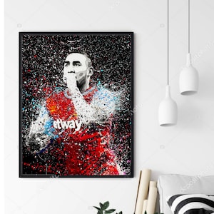 May include: A digital painting of a soccer player in a red and blue jersey with the word "Betway" on the front. The player is wearing a white headband and has a determined expression on his face. The background is black with white and blue paint splatters.
