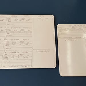 May include: Two white game character sheets with printed sections for stats, equipment, and advancements. One sheet is rectangular, the other is square. The sheets are on a dark blue surface. The text on the sheets is in a light gray color.