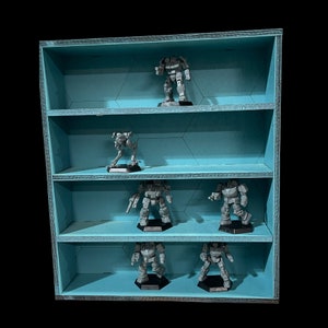 May include: A blue wooden shelf unit with six compartments, each holding a grey plastic miniature robot figure. The shelf unit has a light blue background.