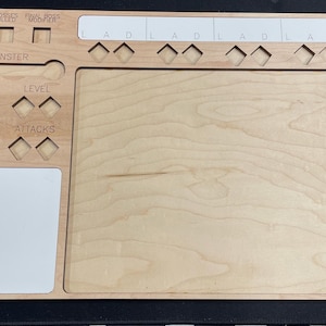 May include: A wooden game tray with slots for dice and tokens. The tray has labels for "Monster", "Number", "Level", "Life Points", and "Attacks".