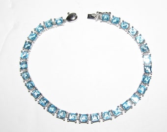 10K White Gold Tennis Bracelet W/ Square Faceted Light Blue Topaz 7"