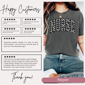 May include: A grey t-shirt featuring a black and white chequered "NURSE" graphic. The shirt is modelled on someone wearing blue jeans. Customer reviews are displayed with five-star ratings and positive comments about the shirt's quality, fit, and comfort.