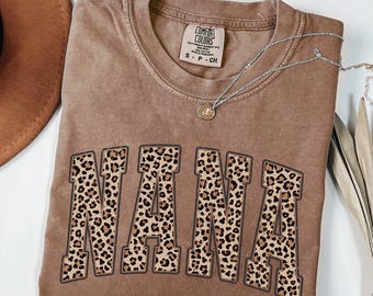 May include: Espresso brown t-shirt with a leopard print "NANA" graphic. The shirt is made of a soft, comfortable fabric and has a relaxed fit.