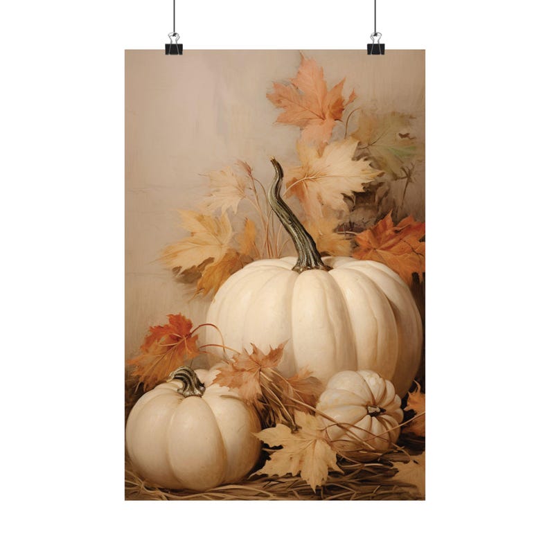 May include: A poster print featuring a still life of white pumpkins and autumn leaves. The pumpkins vary in size, with a large one in the center and smaller ones on either side. The leaves are in shades of orange, red, and yellow.