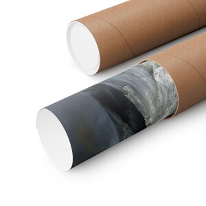 May include: Two rolled posters in brown cardboard tubes. One tube is partially unrolled, revealing a landscape print with shades of gray and white. The other tube is closed with a white cap.