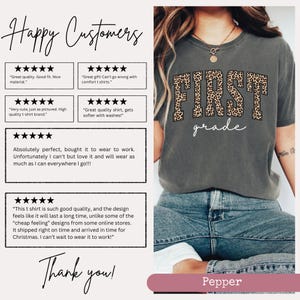 May include: A gray t-shirt with the words "First Grade" in brown text with a leopard print design. The shirt is being worn by a person with jeans. The image includes customer reviews with five-star ratings and positive comments about the shirt's quality and fit.