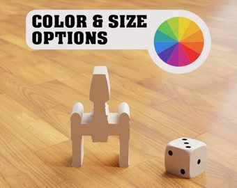 May include: White plastic model of a spaceship with a white dice on a wooden surface. The text "COLOR & SIZE OPTIONS" is visible above the spaceship. A rainbow color wheel is visible to the right of the text.