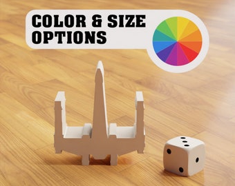 May include: A white model of a spaceship with a color wheel and a white die with black dots. The text "COLOR & SIZE OPTIONS" is on a white banner.