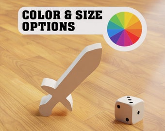 Peut inclure: Une épée blanche, un dé blanc avec des points noirs et une roue chromatique avec le texte "COLOR & SIZE OPTIONS" sur une surface en bois.
