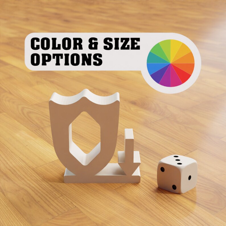May include: A white shield with a downward arrow next to it. The shield has a hexagonal cutout in the center. A white die with black dots is on a wooden surface. The text "COLOR & SIZE OPTIONS" is on a white banner with a rainbow color wheel.