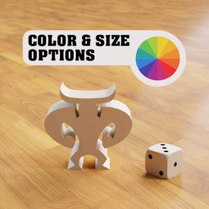 May include: White, abstract, three-dimensional sculpture with a dice on a wooden surface. The sculpture is shaped like a stylized human figure. The dice is white with black dots. The background is a light wood grain.