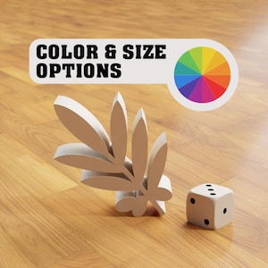 May include: A white, three-dimensional branch with leaves, and a white dice with black dots on a wood floor. The text "COLOR & SIZE OPTIONS" is on a white banner with a rainbow color wheel.