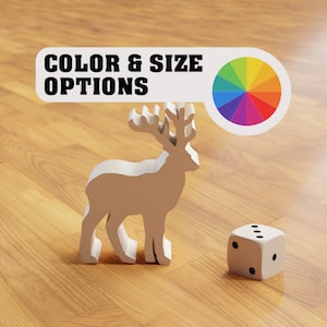 May include: A white wooden reindeer figurine with a colour wheel and the text "COLOR & SIZE OPTIONS" above it. A white die with black dots is on the wooden floor.