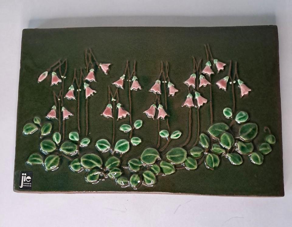 Vintage Swedish Jie Gantofta Dark Green Glazed Ceramic Wall Plaque with Linnea, designed by Aimo Nietosvuori, hand painted