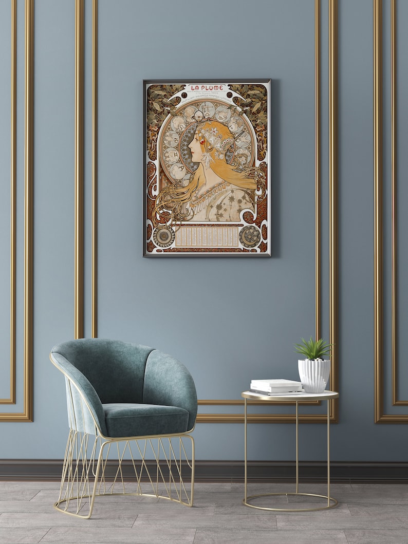 May include: A framed art print of a woman with long flowing hair, surrounded by intricate floral and geometric designs. The print is titled "La Plume" and features a calendar with the months of the year.